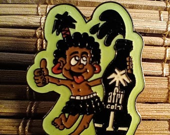 May include: A vintage Afri-Cola pin featuring a cartoon character with a thumbs-up gesture, holding a bottle of Afri-Cola. The pin has a green outline and is set against a bamboo background. The character is brown-skinned with a black skirt.