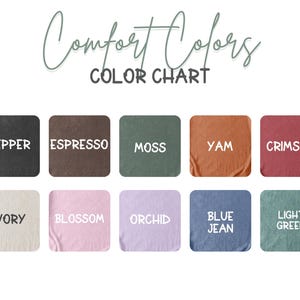 May include: A color chart displaying various Comfort Colors. The chart features ten fabric swatches in shades like Pepper, Espresso, Moss, Yam, Crimson, Ivory, Blossom, Orchid, Blue Jean, and Light Green. The words "Comfort Colors" and "COLOR CHART" are at the top.