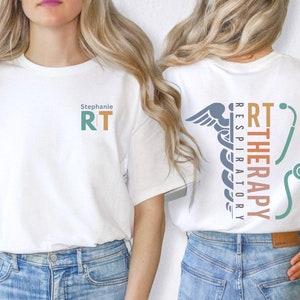 May include: White t-shirt with the text "Stephanie RT" on the front and a graphic of a caduceus with the text "RT THERAPY RESPIRATORY" on the back.