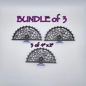 May include: A set of three black plastic 4 inch by 2 inch decorative wall panels with a geometric design. The panels have suction cups for hanging. The text "Bundle of 3" and "3 of 4" x 2" are printed on the image.