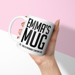 May include: White ceramic mug with black text that reads "Emma's Mug (p.s. this is probably contains gin)"