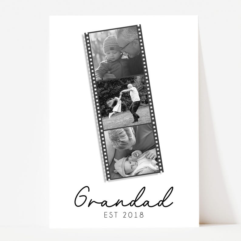 May include: Black and white print featuring a film strip of family photos. The word "Grandad" is written in cursive, with "EST 2018" below. The film strip shows a baby with a grandparent, a child dancing, and a baby being held.