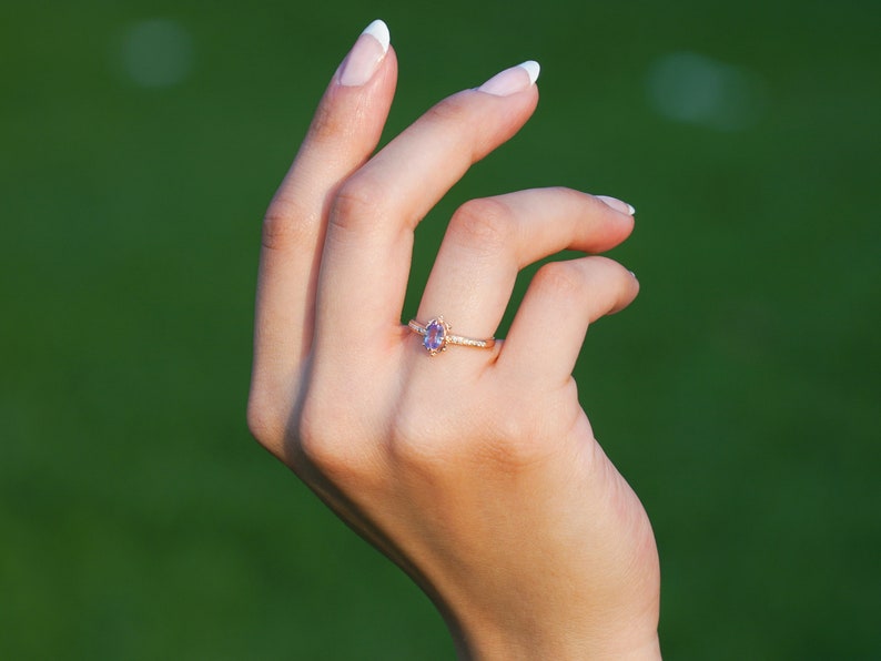 Vintage alexandrite diamond solid gold ring on the finger. Unique vintage color changing Alexandrite ring. Solid gold diamond engagement Ring, 8K Solid gold moissanite Ring. Ethical diamond dainty bridal ring on the finger, Tali Jewelry Ring