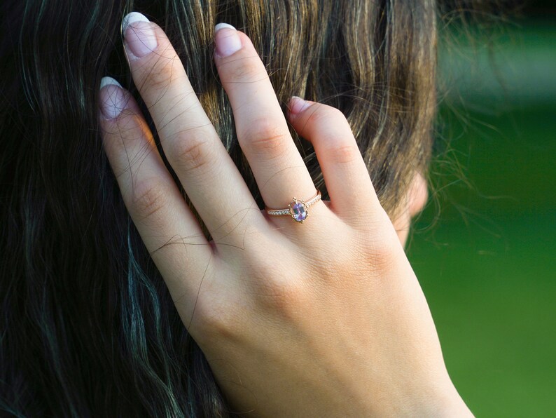 Vintage alexandrite diamond solid gold ring on the finger. Unique vintage color changing Alexandrite ring. Solid gold diamond engagement Ring, 8K Solid gold moissanite ring. Ethical diamond dainty bridal ring on the finger, Tali Jewelry Ring