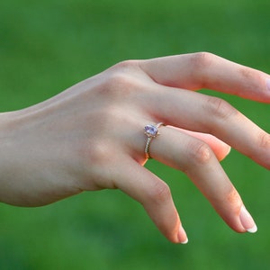 Vintage alexandrite diamond solid gold ring on the finger. Unique vintage color changing alexandrite ring. Solid gold diamond engagement Ring, 8K Solid gold Moissanite ring. Ethical diamond dainty bridal ring on the finger, Tali Jewelry Ring