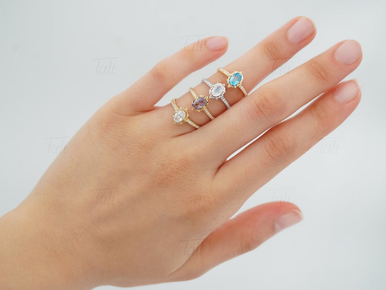 unique vintage diamond engagement ring with white topaz, alexandrite on the finger. Unique moissanite wedding ring with moonstone on the finger. Solid gold unique dainty engagement proposal ring with alexandrite on the finger. Tali Jewelry Rings