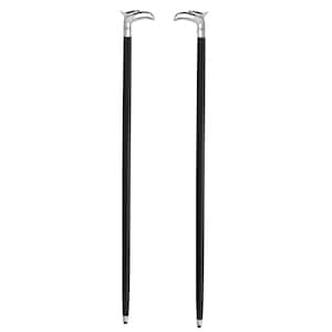 May include: Two black walking sticks with silver eagle head handles. The sticks have a polished appearance, with a silver band where the handle meets the black shaft. The tips of the sticks are also silver.