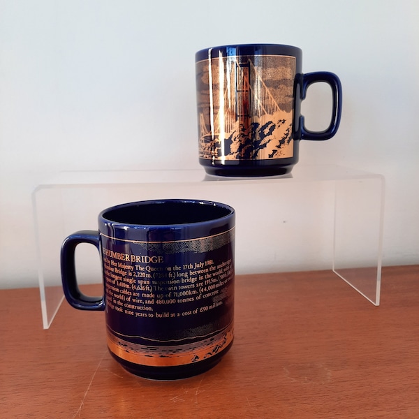 two blue gold Hornsea Pottery mugs | gold illustration on cobalt blue mug celebrating 1981 opening of the Humber Bridge | 1980s memorabilia