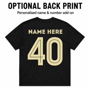 May include: A black short-sleeved t-shirt featuring the text OPTIONAL BACK PRINT and Personalised name & number add-on at the top. The back of the shirt displays the words NAME HERE in a light beige font above the large number 40 in the same color.