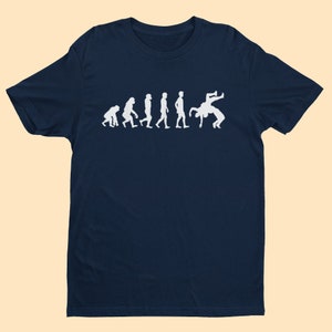Maglietta Evolution Of Wrestling, dalla scimmia all'uomo preistorico fino ai lottatori che lottano con manovre ad alto rischio
