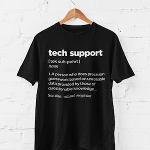 May include: Black t-shirt with white text that reads "tech support [tek suh-pohrt] noun 1. A person who does precision guesswork based on unreliable data provided by those of questionable knowledge... See also: wizard, magician"