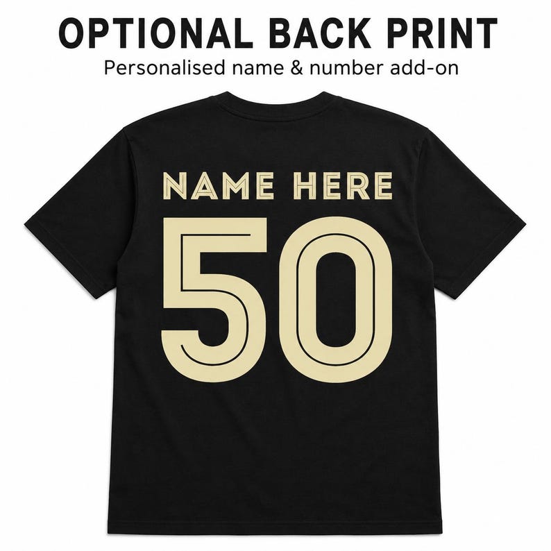 May include: A black short-sleeved t-shirt featuring the text OPTIONAL BACK PRINT and Personalised name & number add-on at the top. The back of the shirt displays the text NAME HERE in beige above the large beige number 50 with a black outline.