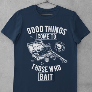 May include: Navy blue t-shirt with a white graphic of fishing gear and the text "Good things come to those who bait".
