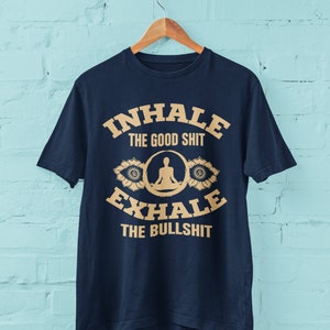 Funny Yoga T Shirt Inhale The Good Sh*t Exhale The Bullsh*t with mandala om graphics and silhouette in lotus pose yogi gift ideas