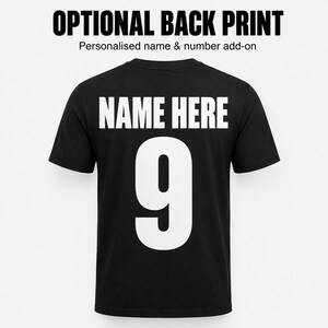 May include: A black short-sleeved t-shirt featuring the white text OPTIONAL BACK PRINT, the subtext Personalised name & number add-on, and the large white text NAME HERE above the large white number 9 centered on the back of the garment.