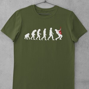 May include: A green t-shirt featuring a white graphic of the evolution of man, culminating in a man playing a red electric guitar.