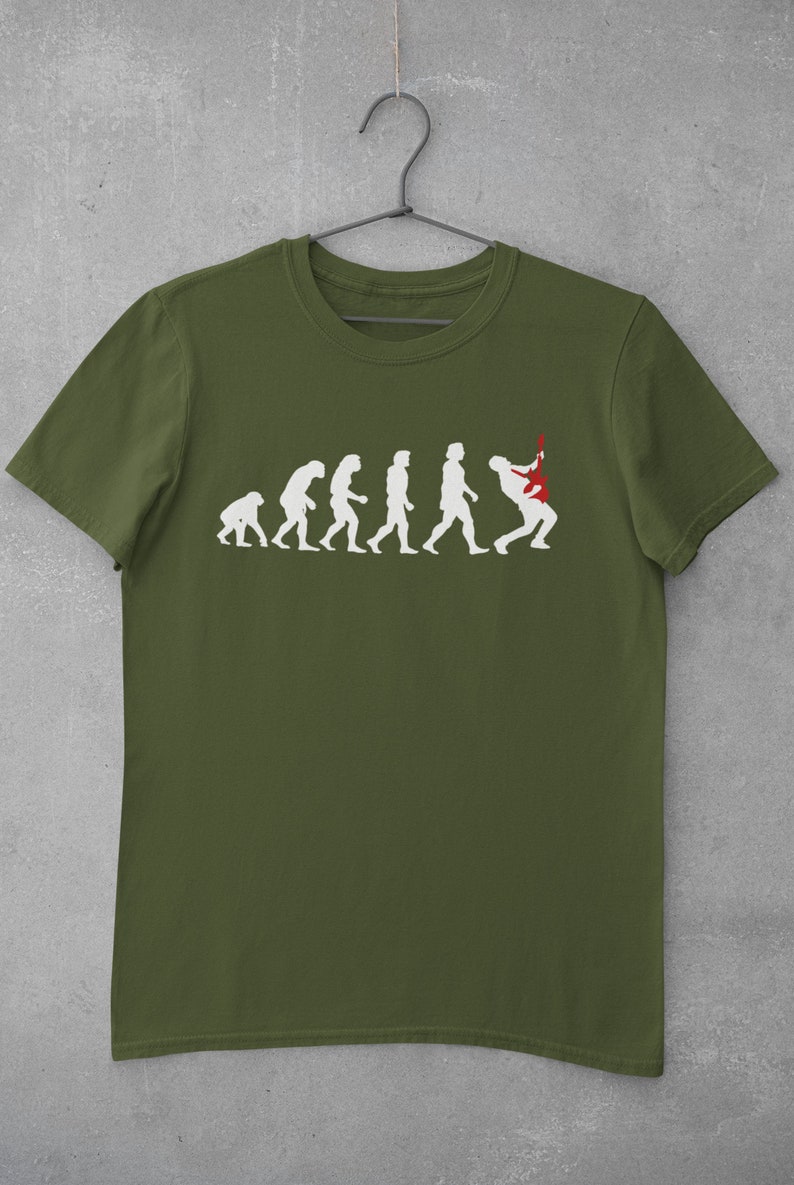 May include: A green t-shirt featuring a white graphic of the evolution of man, culminating in a man playing a red electric guitar.