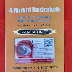 May include: A brown 4 Mukhi Rudraksha bead in a clear plastic case with a red string. The case has a label that says "Natural 4 Face Rudrakasha". The label also includes a description of the bead and a QR code. The text on the label reads: "Specimen description: Bead Colour: Brown Shape/Cut: Uneven/like X-Rays internally same structure Specific comments Observation confirm natural formation. NATURAL RUDRAKSHA 4 MUKHI (NEPAL) For and behalf of the - MAYA GEMS LAB"