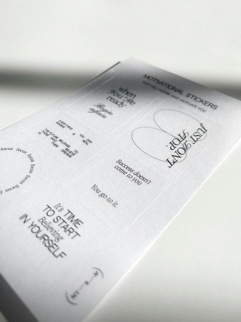 May include: A sheet of white paper with motivational stickers printed on it. The stickers feature inspirational quotes such as "When you're ready, begin again", "Just don't quit", "Success doesn't come to you, you go to it", "It's time to start believing in yourself", and "The future belongs to those who believe in their dreams".