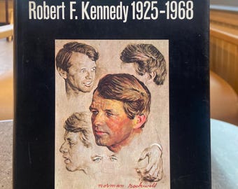 May include: A book titled "ASSASSINATION" with the text "Robert F. Kennedy 1925-1968." The cover features a portrait of Robert F. Kennedy and other illustrations. The book is by the editors of United Press International and Cowles.