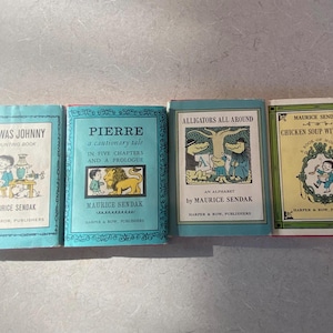May include: Four hardcover books by Maurice Sendak titled One Was Johnny, Pierre, Alligators All Around, and Chicken Soup with Rice. Each book features a distinct illustrated cover with black text on light blue, green, or cream backgrounds.