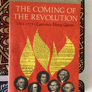 May include: A red book cover with a yellow flame design. The title is "The Coming of the Revolution" with the subtitle "1763-1775 Lawrence Henry Gipson". The book is part of the "The New American Nation Series".