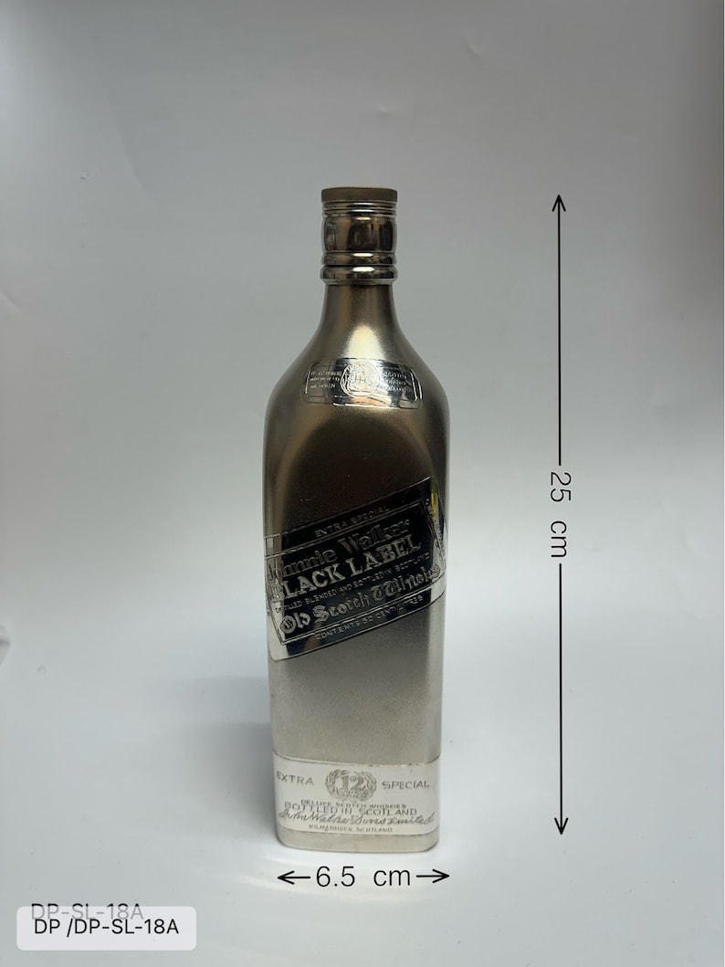 May include: A silver bottle of Johnnie Walker Black Label Scotch Whisky. The bottle is 6.5 inches wide and 25 inches tall. The label reads "Extra Special" and "Bottled in Scotland and Johnnie Walker & Sons Ltd."