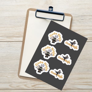 May include: Five round stickers with a white background and a black ninja character holding two swords. The text "Code Ninja" is written in yellow around the character.