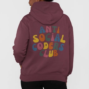 May include: A maroon hoodie with a large, colourful graphic on the back that says "ANTI SOCIAL CODERS CLUB".