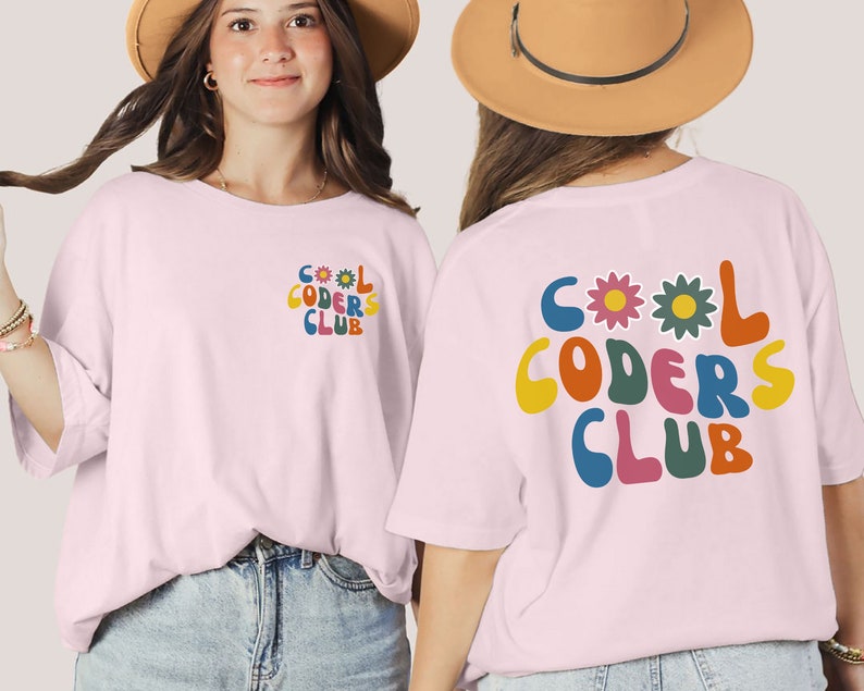 May include: Pink t-shirt with a retro-style graphic that says "COOL CODERS CLUB" in colourful letters with flowers. The graphic is on the back of the shirt.