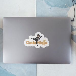 May include: A white sticker with a cartoon ninja holding a computer and the text "Code Ninja" in orange.