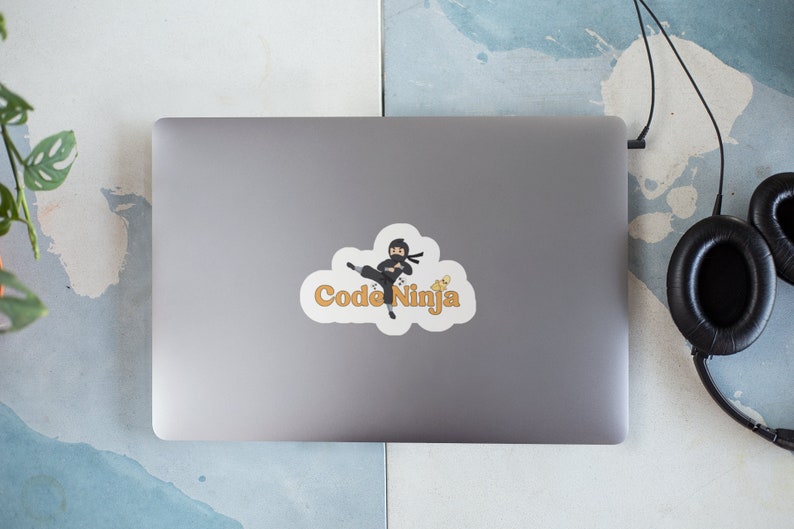 May include: A white sticker with a cartoon ninja holding a computer and the text "Code Ninja" in orange.