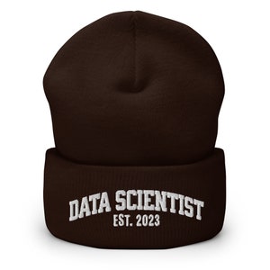 May include: Brown knitted beanie with a white embroidered inscription that reads "DATA SCIENTIST EST. 2023".