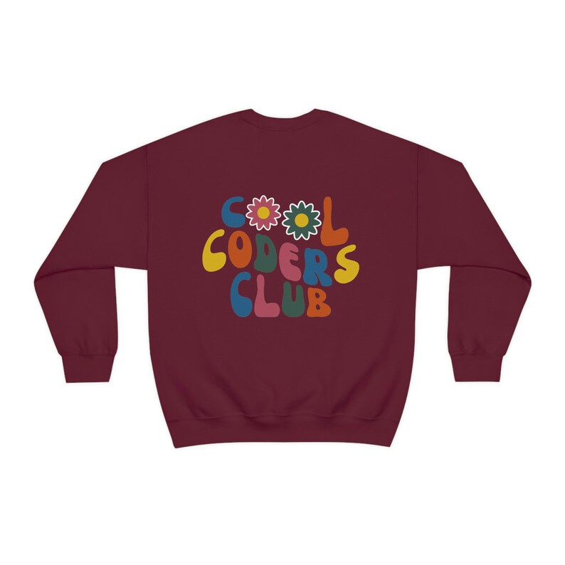 Peut inclure: Sweat-shirt bordeaux avec un graphisme r&eacute;tro qui dit "Cool Coders Club" en lettres color&eacute;es avec des fleurs.