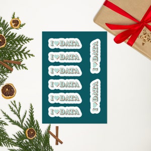 May include: A sheet of teal blue sticker paper with six stickers that say "I ♥ DATA" in a retro font with a red outline and a light blue heart. The stickers are arranged in two columns.