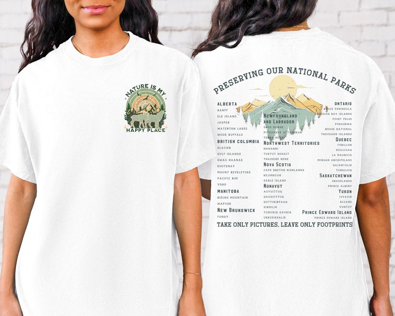 May include: White t-shirt with a green nature scene and the text "Nature is my happy place" on the front. The back of the shirt has a list of Canadian national parks and the text "Preserving our National Parks. Take only pictures, leave only footprints."