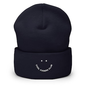May include: A navy blue beanie with a white embroidered smiley face and the text "Cool Coders Club".