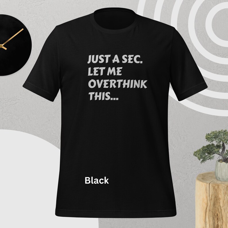 Front view, black color, flat mock-up, Funny Quote T-Shirt - Printed With: 'Just a Sec, Let Me Overthink This' - Unisex Tee for Fans of Funny, Relatable Humor