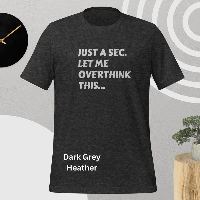 Front view, dark grey heather color, flat mock-up, Funny Quote T-Shirt - Printed With: 'Just a Sec, Let Me Overthink This' - Unisex Tee for Fans of Funny, Relatable Humor