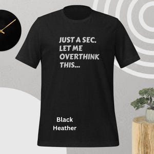 Front view, black heather color, flat mock-up, Funny Quote T-Shirt - Printed With: 'Just a Sec, Let Me Overthink This' - Unisex Tee for Fans of Funny, Relatable Humor
