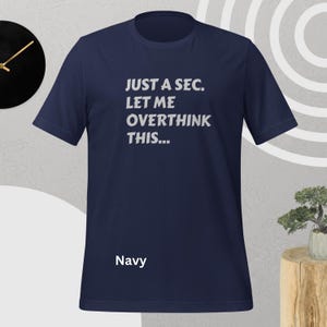 Front view, navy color, flat mock-up, Funny Quote T-Shirt - Printed With: 'Just a Sec, Let Me Overthink This' - Unisex Tee for Fans of Funny, Relatable Humor