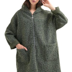 May include: A long, green hooded jacket with a zipper closure and two pockets. The jacket has a textured, fuzzy fabric.
