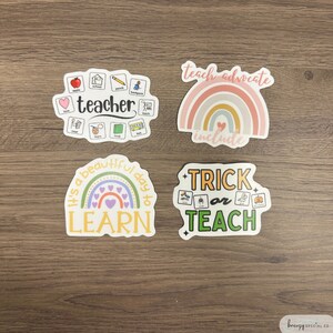 May include: Four colorful stickers with educational themes. The first sticker is a circle with the word "teacher" in the center and various icons around it. The second sticker is a rainbow with the text "teach advocate include". The third sticker is a rainbow with the text "it's a beautiful day to learn". The fourth sticker is a green and orange sticker with the text "trick or teach".