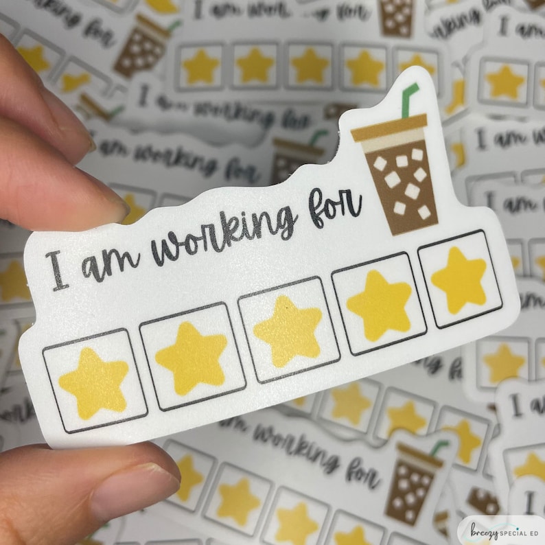 May include: White sticker with the text "I am working for" and five yellow star icons. The sticker has a brown and white coffee cup icon with a straw.