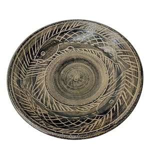 May include: A set of three ceramic mugs with a speckled, matte finish. Each mug features a different color: light blue, cream, and gray. The mugs have a simple, modern design and a comfortable handle.