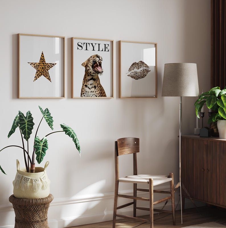 May include: Three framed prints with a white background. The left print features a star-shaped design with a leopard print pattern. The middle print features a leopard print design with the word "STYLE" in black text. The right print features a leopard print design of a pair of lips.