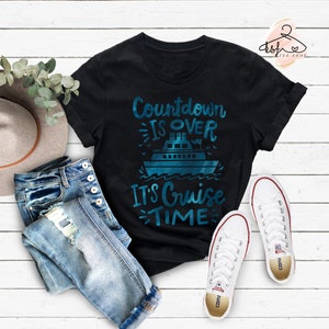May include: Black t-shirt with a blue graphic of a cruise ship and the text "Countdown is over, It's Cruise Time".
