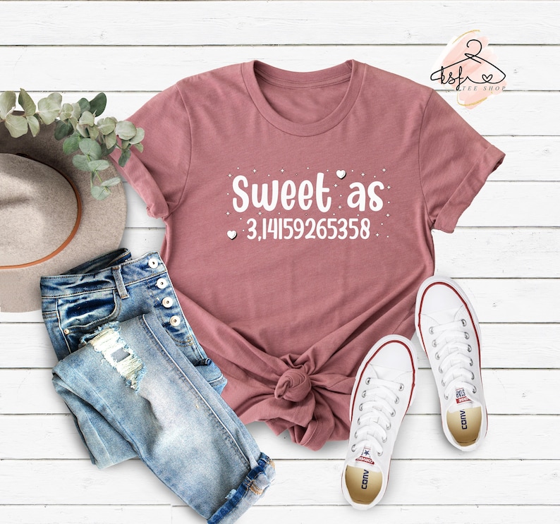May include: A mauve t-shirt with the text "Sweet as 3.14159265358" in white with small hearts around the text.