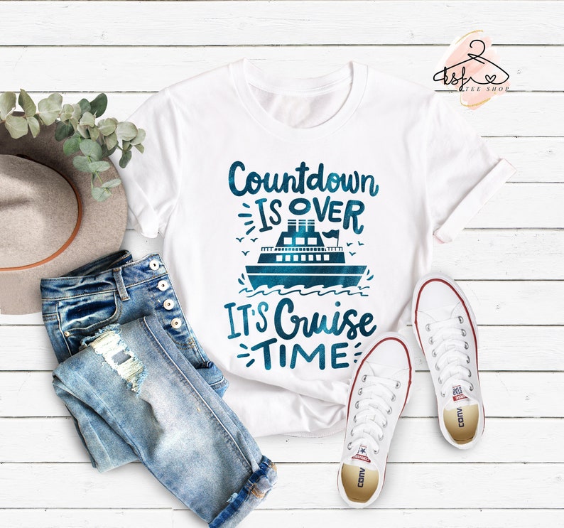May include: White t-shirt with a blue cruise ship graphic and the text "Countdown is over, It's Cruise Time".