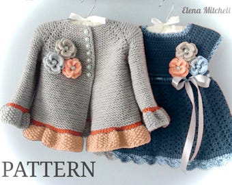 May include: Two handmade crochet garments: a grey cardigan and a blue dress. The cardigan has floral embellishments and pearl buttons. The dress features a ribbon and floral accents. Both have decorative trim and are displayed on hangers.